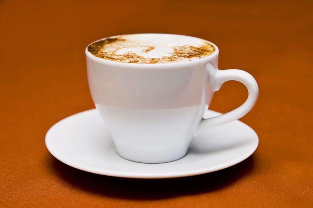 A Flat White presented in a ceramic cup, showcasing a double shot of espresso with creamy microfoam on top.