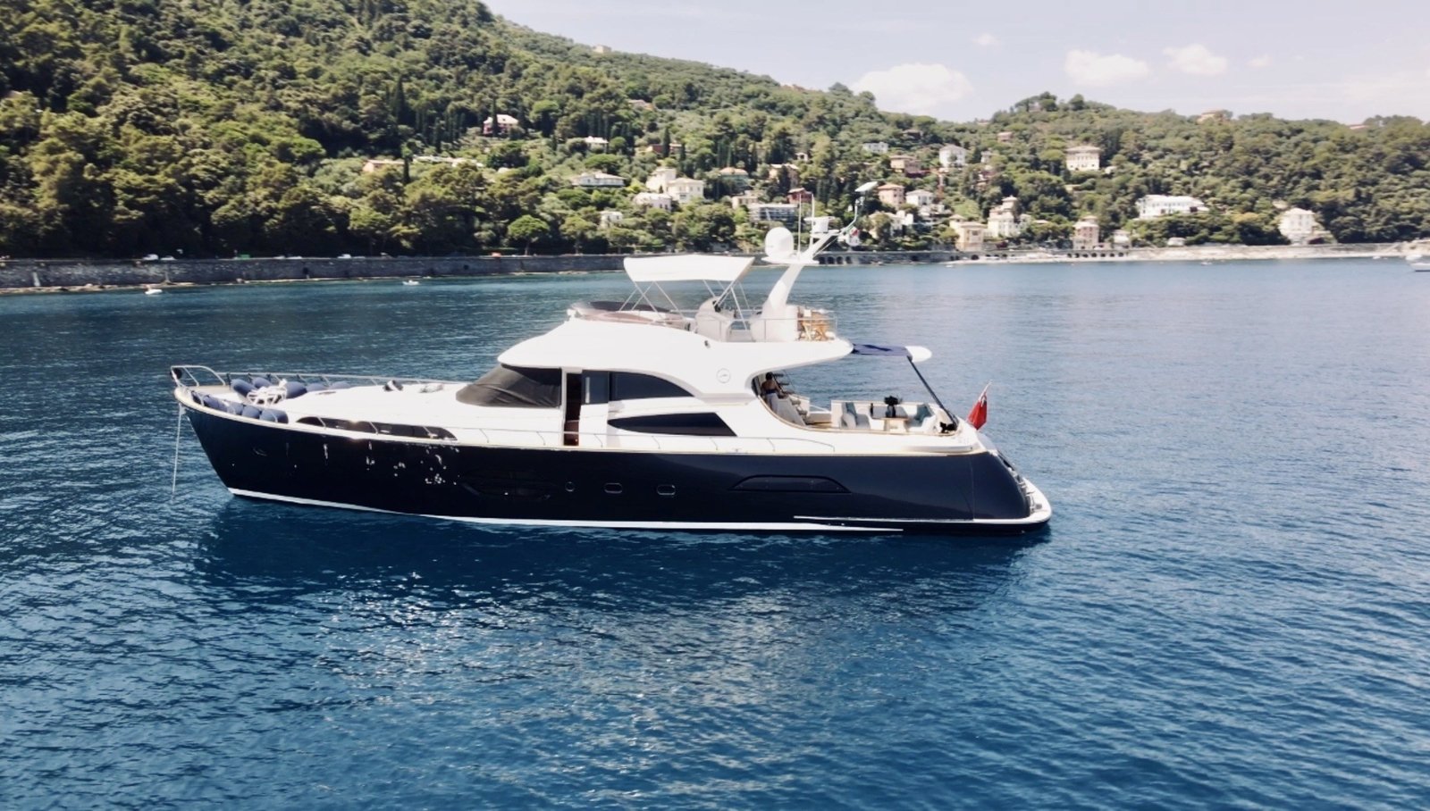 M/Y Contango, 2006 Mochi Craft Dolphin 74, starboard profile at anchor off the Ligurian coast