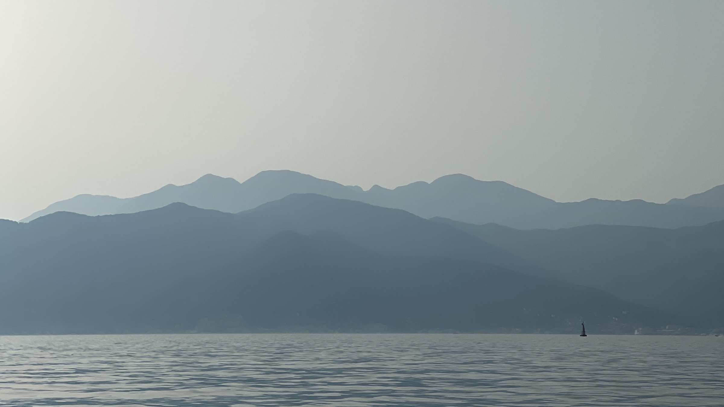 Mountains and small yacht in the lake