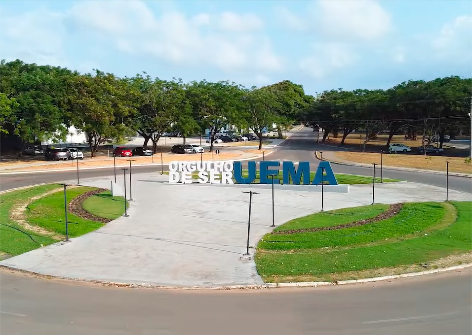 Área externa do campus da UEMA, com o letreiro “Orgulho de ser UEMA” e arborização ao redor