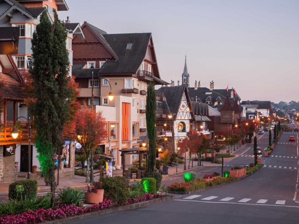Centro de Gramado iluminado ao entardecer, com arquitetura de inspiração europeia