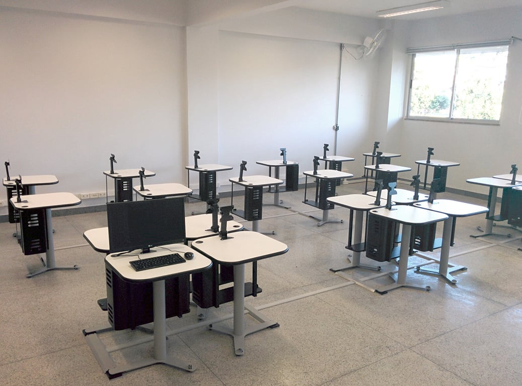 Laboratório de informática universitário, com fileiras de computadores e ambiente moderno