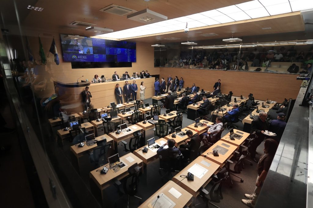 Plenário de uma câmara municipal brasileira, com mesas e microfones, ambiente moderno e bem iluminado