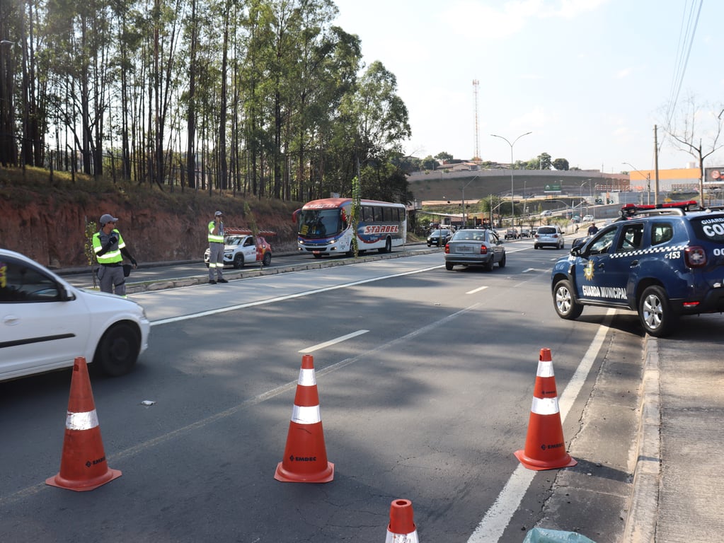 Operação de controle de tráfego com cones, agentes e viatura da Guarda Municipal em via urbana