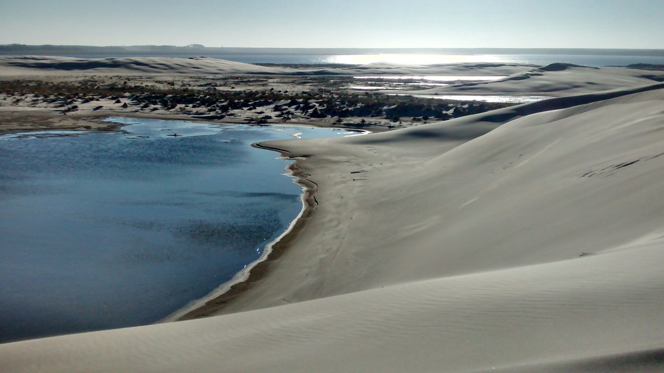 Vista aérea de praia e dunas no litoral de Mostardas (RS), com lago interno ao fundo