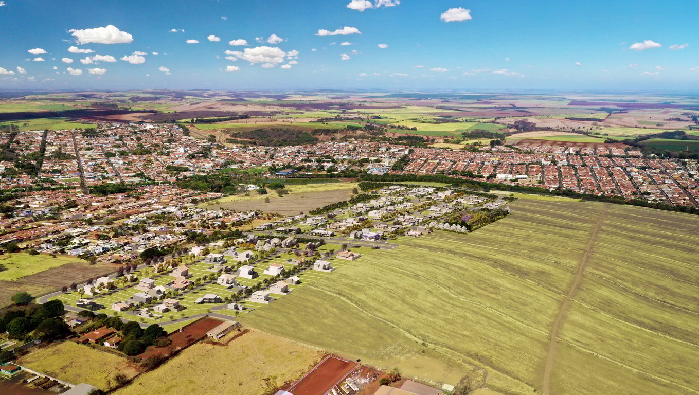 Vista aérea de Cotia (SP) ao entardecer, com bairros urbanos e áreas verdes.