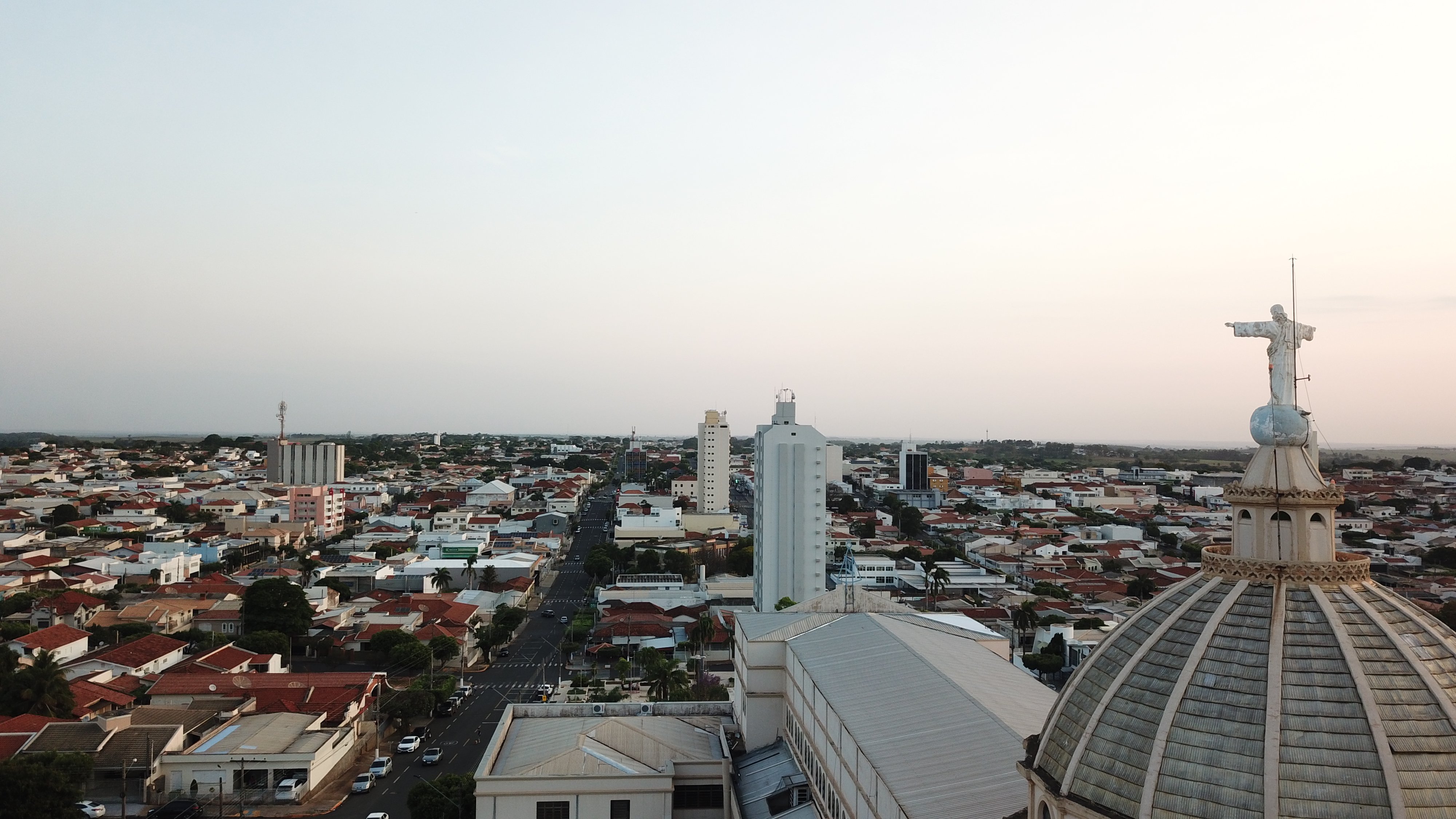 Vista aérea de Dracena SP, com área urbana e trechos verdes em dia claro
