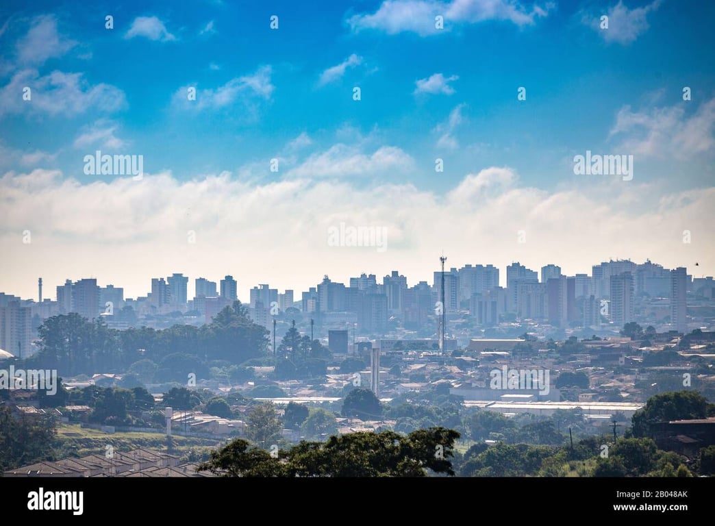 Vista aérea de Bauru ao entardecer, com prédios e áreas verdes