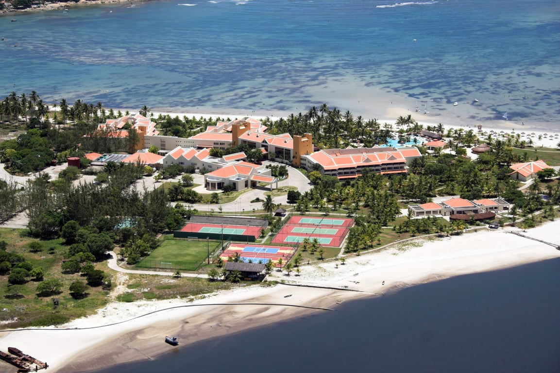 Vista aérea de Cabo de Santo Agostinho, com praias e área urbana ao fundo, em dia ensolarado