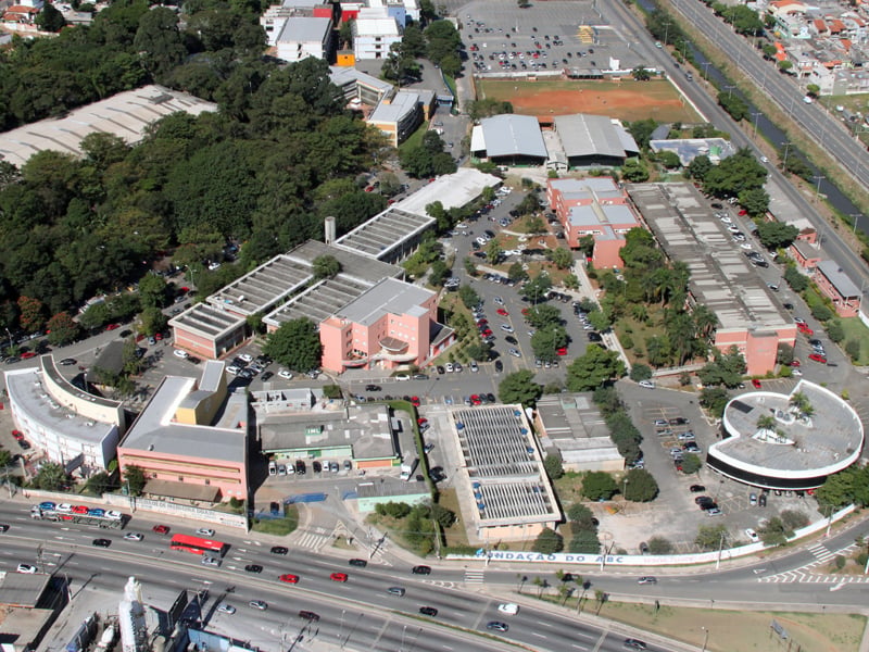 Ambiente universitário/campus da Fundação Santo André, com prédios acadêmicos e estacionamento