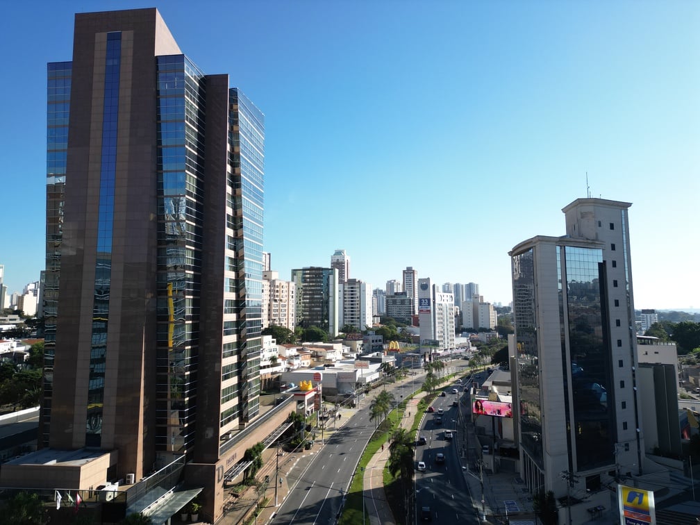 Horizonte urbano de Campinas ao entardecer, com prédios e áreas verdes