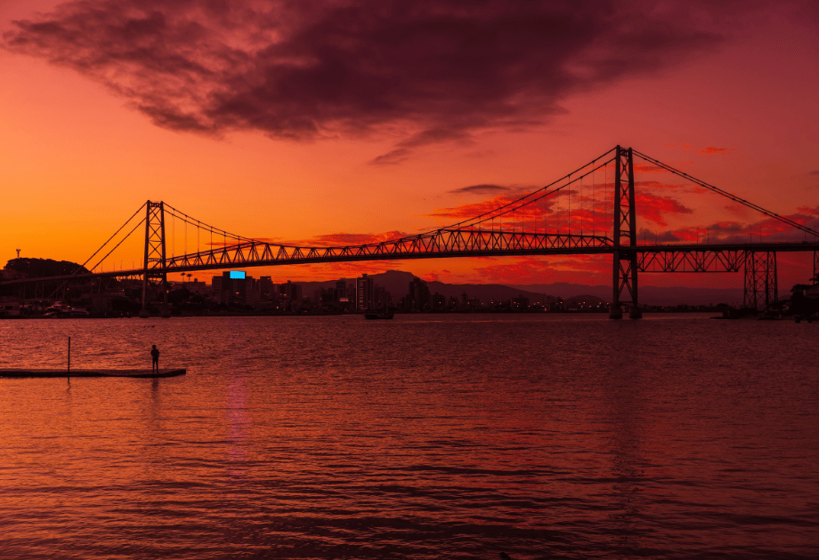 Ponte Hercílio Luz ao entardecer com a cidade ao fundo