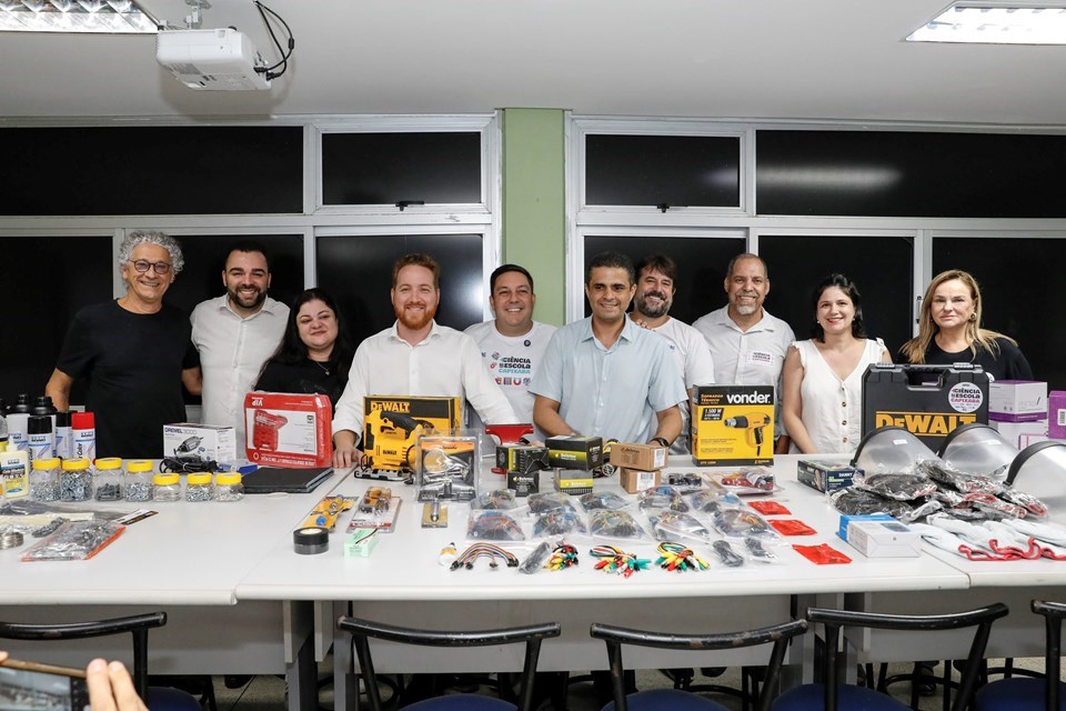 Laboratório de tecnologia educacional com kits de robótica e laptops em ambiente universitário brasileiro