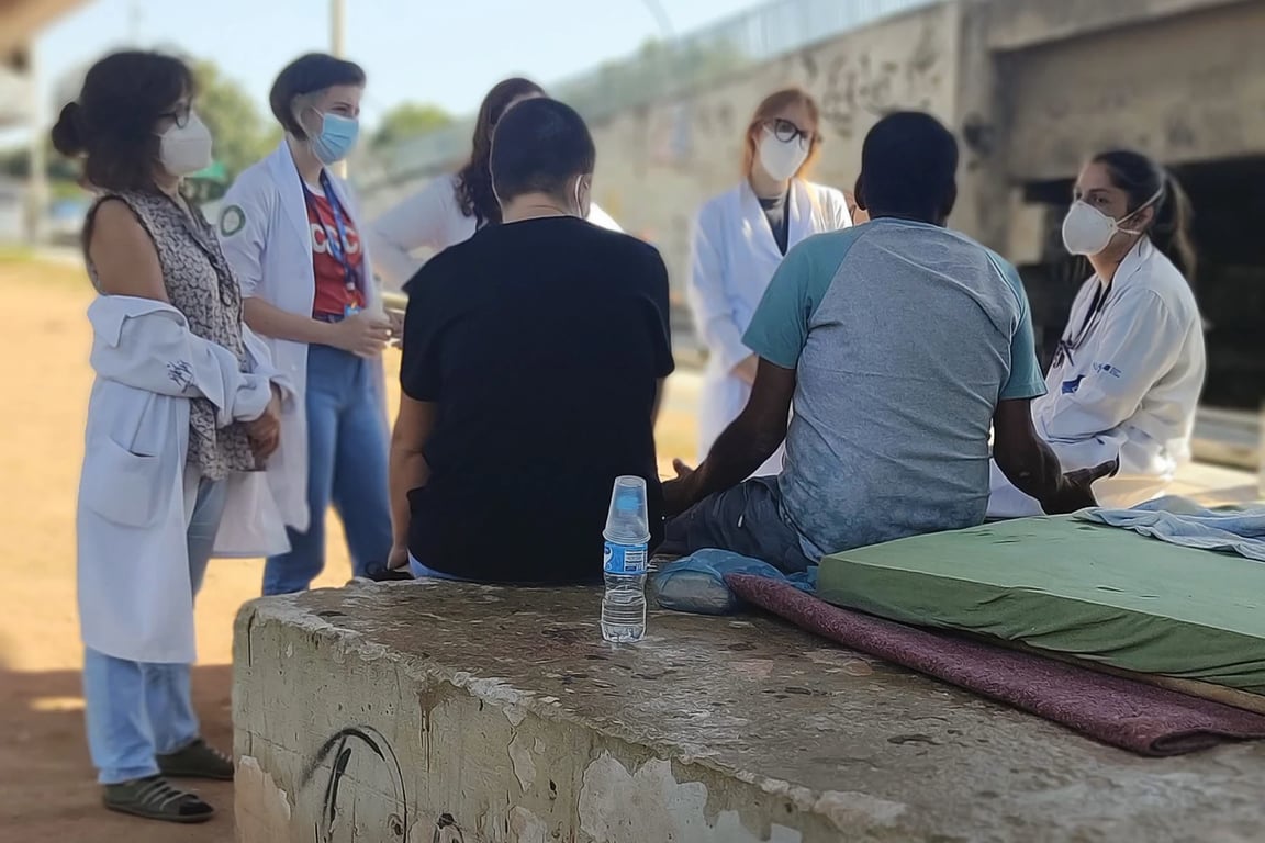Agentes comunitários de saúde atendendo moradores em bairro de cidade pequena