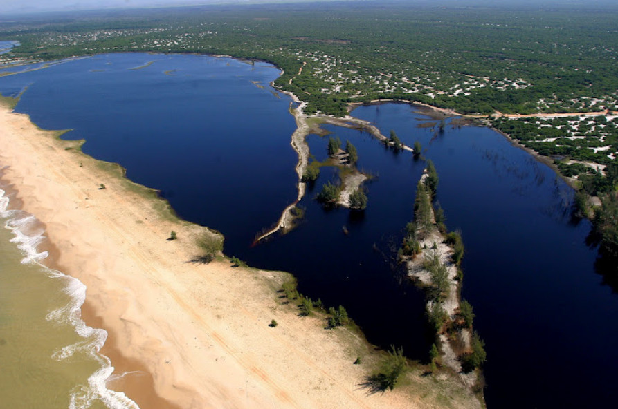Vista aérea das lagoas costeiras e da vegetação de restinga do Parque Nacional da Restinga de Jurubatiba. Paisagem sob luz dourada, com praias e vegetação visíveis.