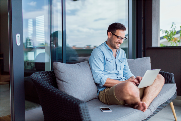 manager sitting on his sofa while working remotely