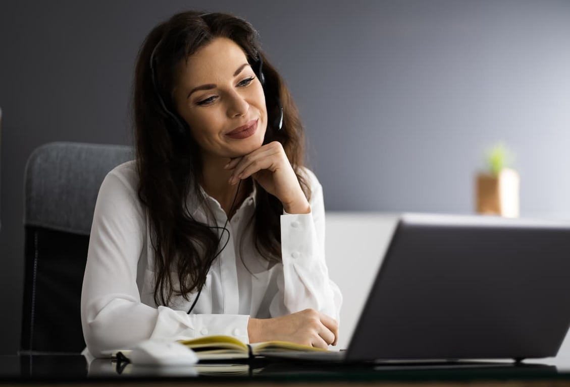 a virtual assistant working in her laptop communicating with her remote team