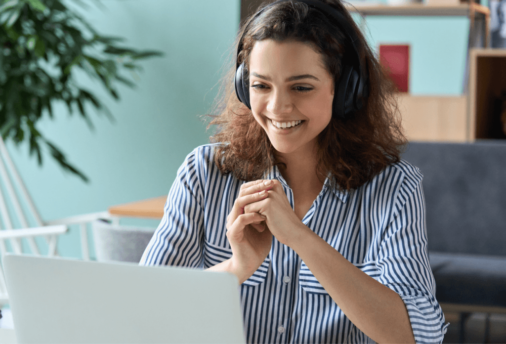women smile in front of laptop