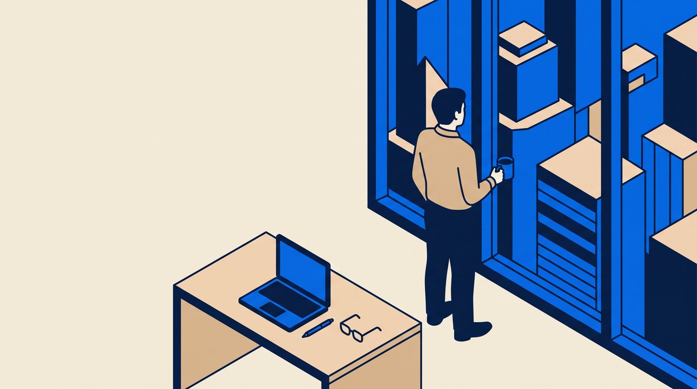 Analyst in shirtsleeves at a high office window holding coffee, closed laptop on the desk behind
