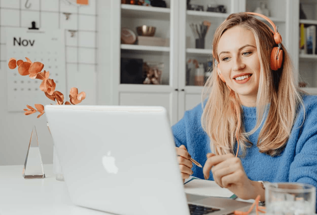 a VA smiling in front of her laptop