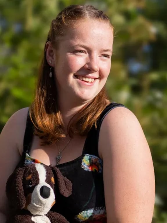 Young woman with her service dog toy