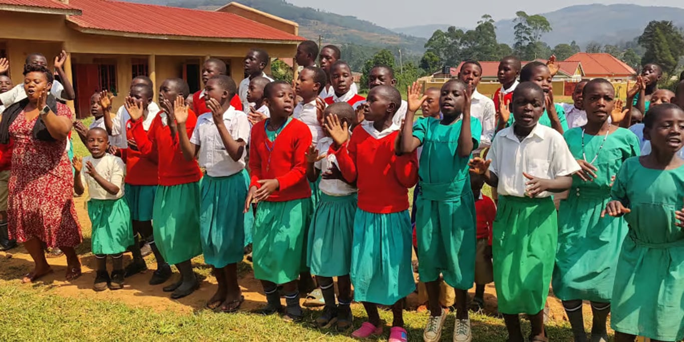 Schoolchildren singing outside their school