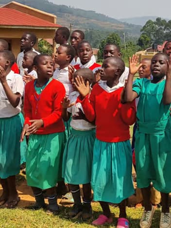 Schoolchildren singing outside their school