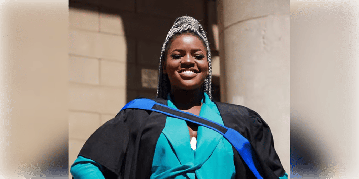 Graduate smiling in cap and gown
