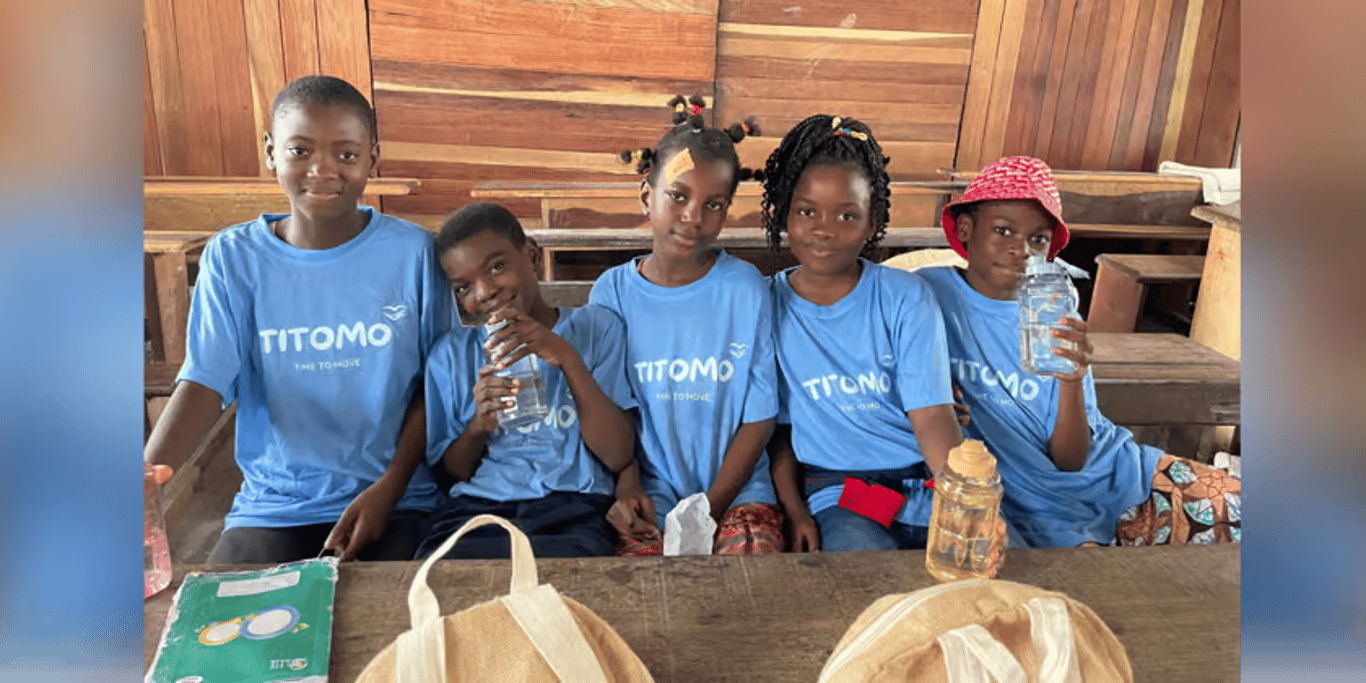 Schoolchildren with water bottles at their desks
