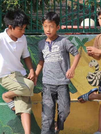 Children playing at a school wall mural
