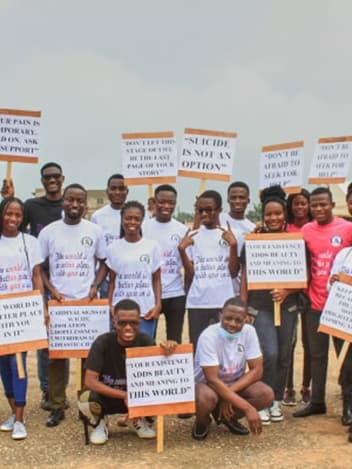 Youth awareness campaign group with signs