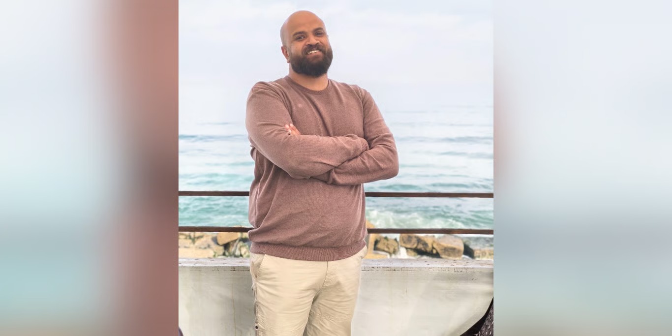 Educator standing by the sea