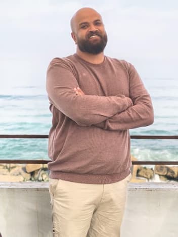 Educator standing by the sea