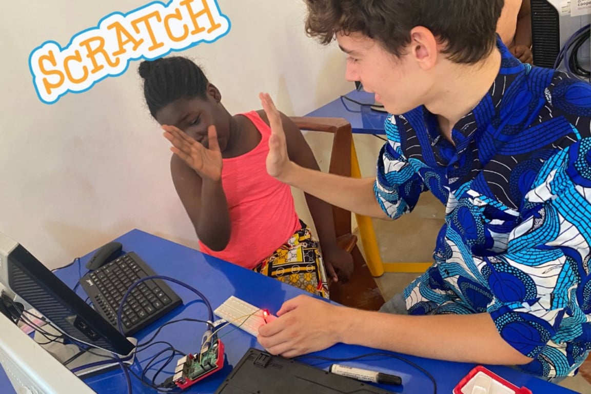 Volunteer teaching a girl coding with Scratch