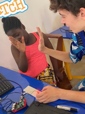 Volunteer teaching a girl coding with Scratch