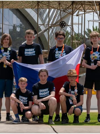 Young robotics team with their national flag