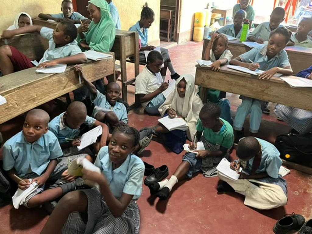 Pupils studying on a classroom floor