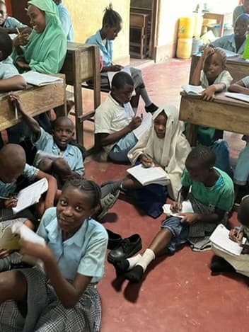 Pupils studying on a classroom floor