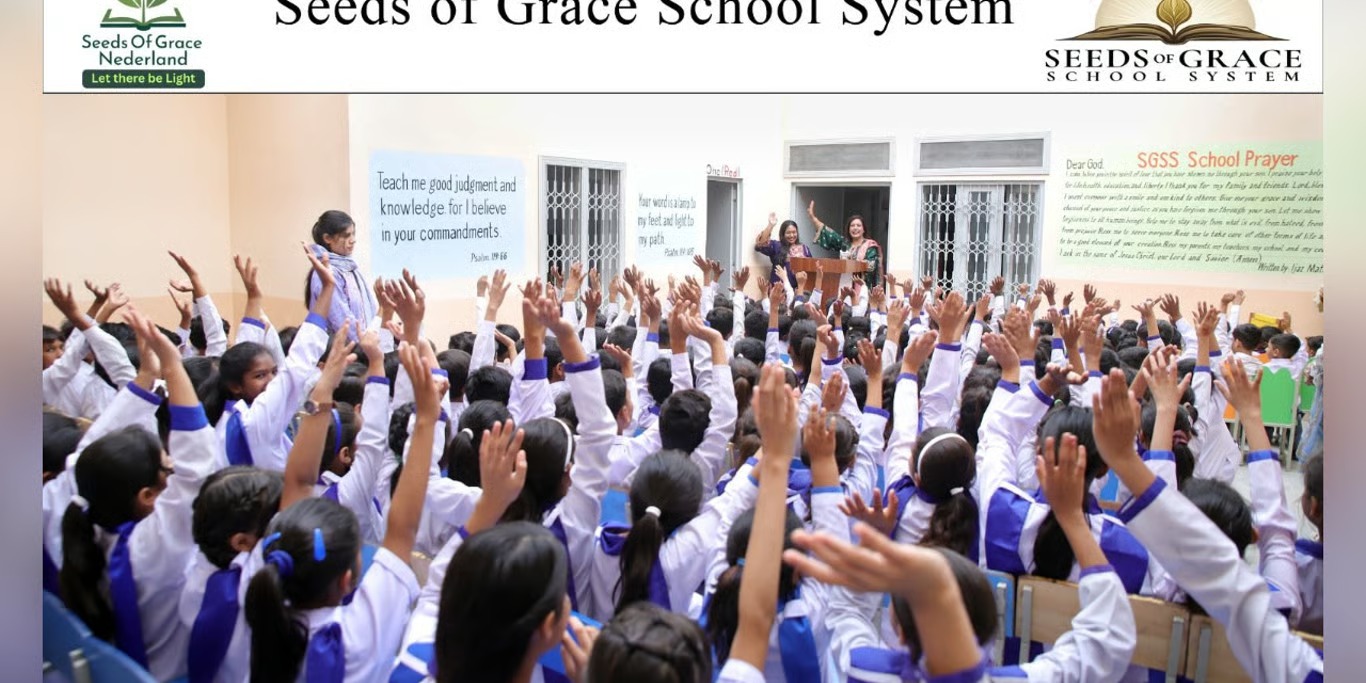 Pupils raising their hands at Seeds of Grace school