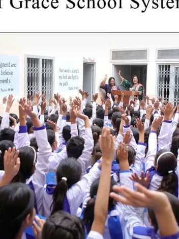 Pupils raising their hands at Seeds of Grace school