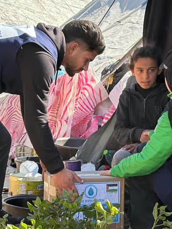 Volunteer delivering an aid package to a family