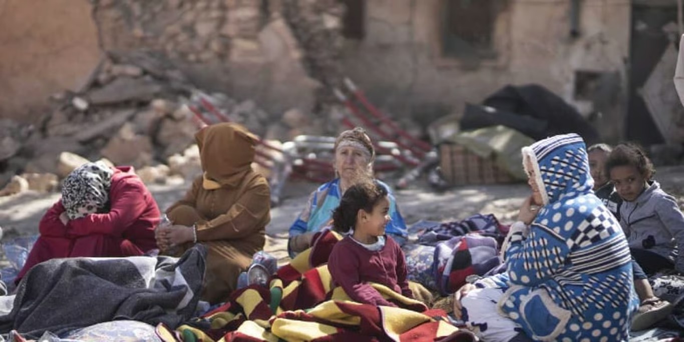 Families sheltering outdoors after an earthquake