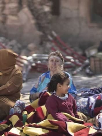 Families sheltering outdoors after an earthquake