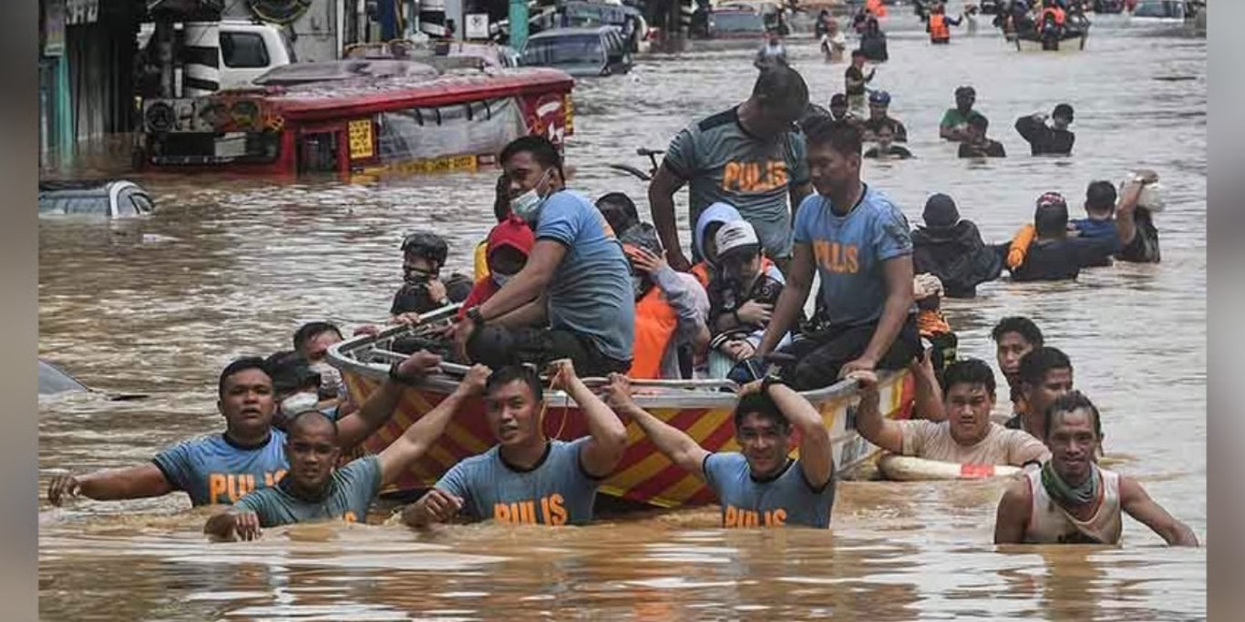 Rescue team guiding a boat through floodwater