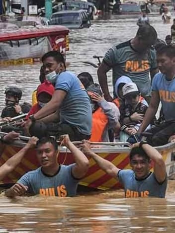 Rescue team guiding a boat through floodwater
