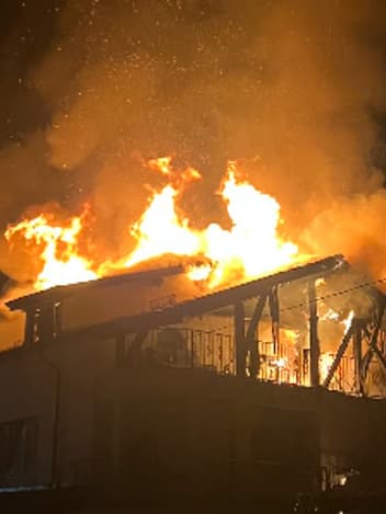 House engulfed in flames at night