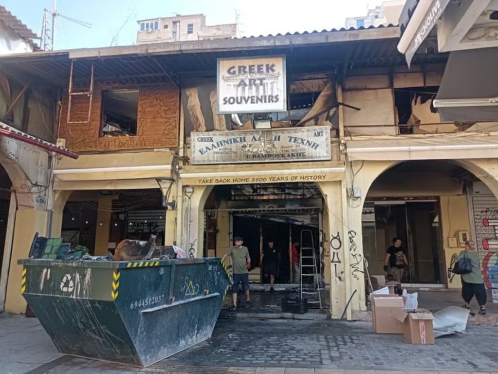 Shop owners cleaning up after a fire