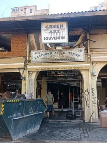 Shop owners cleaning up after a fire
