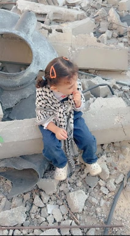 Little girl sitting on rubble