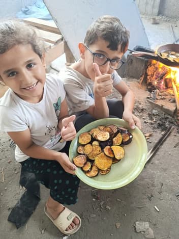 Children sharing a plate of cooked food